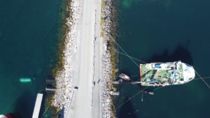 Installing the flowpipe through the pier outside Nova Sea, Lovund